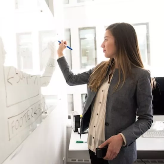Photo of student writing on white board