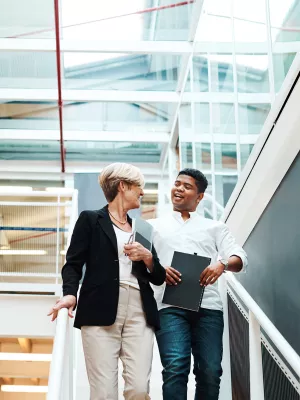 shot of two businesspeople walking down a staircase