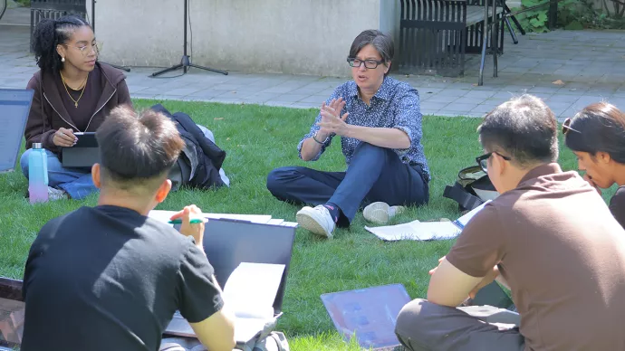 Tara Vinodrai teaches students outdoors on a patch of grass