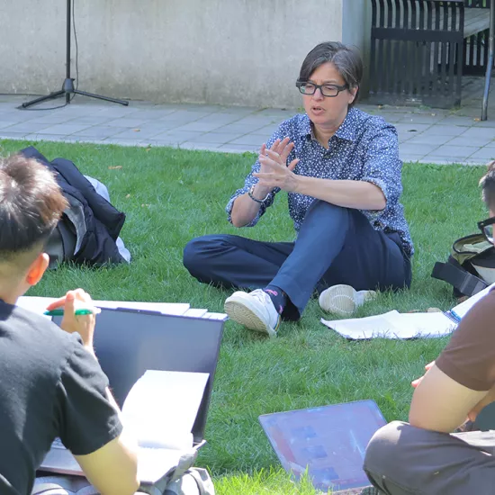 Tara Vinodrai teaches students outdoors on a patch of grass
