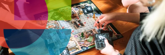 Four students playing a board game